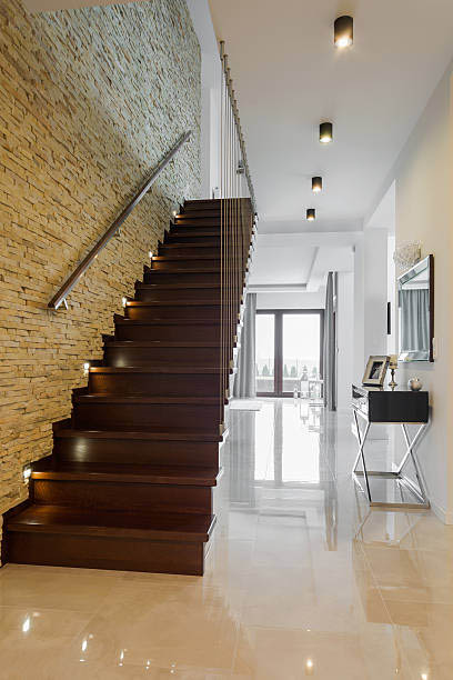 Classic style hallway with marble floor and wooden stairs